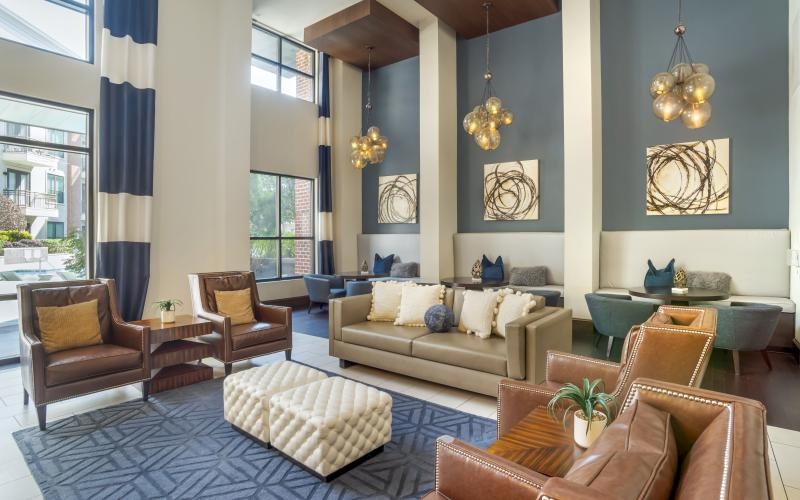a lounge with seating and tables