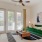 a living room with a green couch and a fan