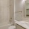 a bathroom with a sink mirror and a toilet