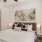 a bedroom with a large bed lamps and ceiling fan