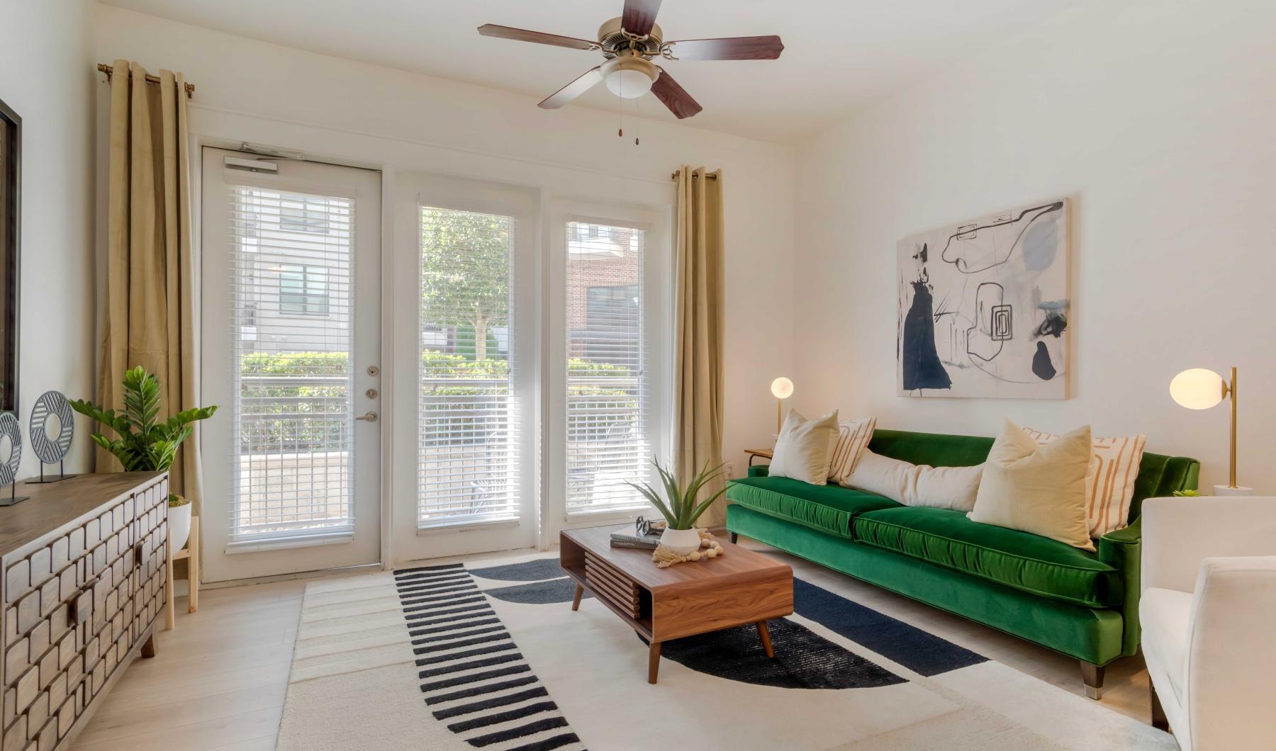 Beautiful living areas to match your lifestyle a living room with a green couch and a fan