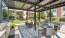 a patio with grills tables and chairs