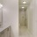 a bathroom with a shower sink and large mirror