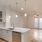a kitchen with white cabinets and wood flooring