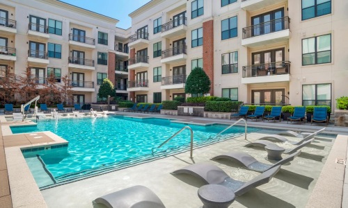 a pool in a courtyard between buildings