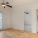 a room with white cabinets and a ceiling fan