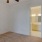 a room with carpet a ceiling fan and a mirror