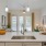 a kitchen with a sink and bowl of oranges on a counter