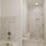 a bathroom with a tub toilet and shower