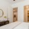 a bedroom with a bed dresser and a mirror