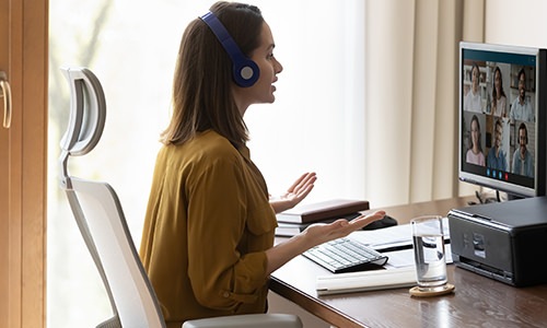 woman sitting at a desk looking at a computer