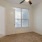 a room with carpet a ceiling fan and a window